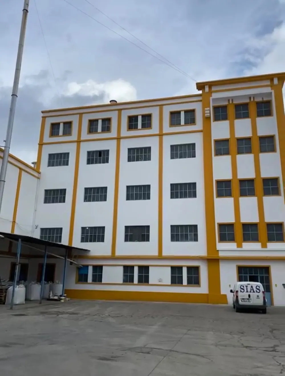 Edifício industrial pintado de branco e amarelo